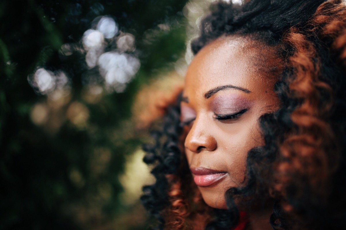 daily happiness woman meditating with eyes closed